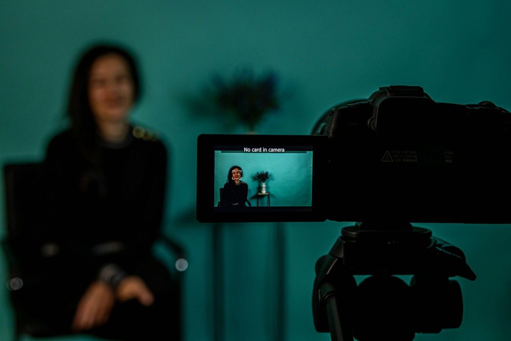 Video camera on a tripod recording an interview
